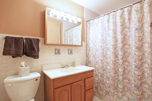 full bathroom with vanity, curtained shower, tile patterned floors, toilet, and tile walls