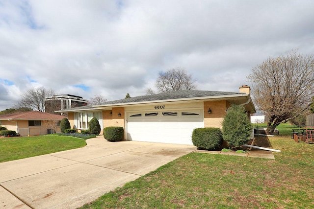 view of front of house with a garage, a chimney, brick siding, a front lawn, and driveway