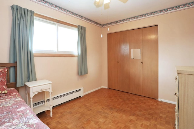 bedroom featuring a closet, a baseboard heating unit, and baseboards