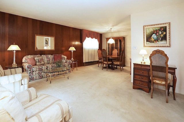 carpeted living room featuring wooden walls