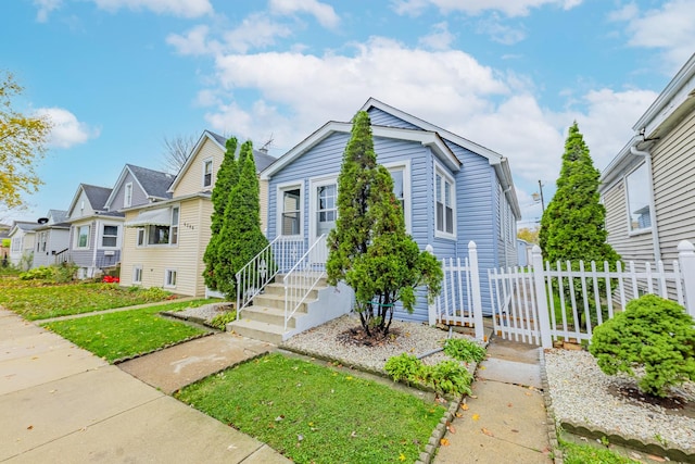 bungalow-style house featuring a residential view and fence