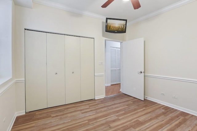 2317 W Wolfram St Unit 211, Chicago, IL 60618 - unfurnished bedroom featuring light wood-type flooring, ornamental molding, a closet, baseboards, and ceiling fan