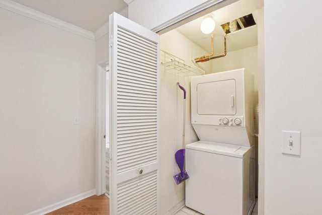 2317 W Wolfram St Unit 211, Chicago, IL 60618 - laundry area featuring estacked washer and dryer, ornamental molding, and baseboards