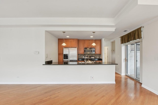 2317 W Wolfram St Unit 211, Chicago, IL 60618 - kitchen featuring appliances with stainless steel finishes, light wood finished floors, dark countertops, tasteful backsplash, and brown cabinetry