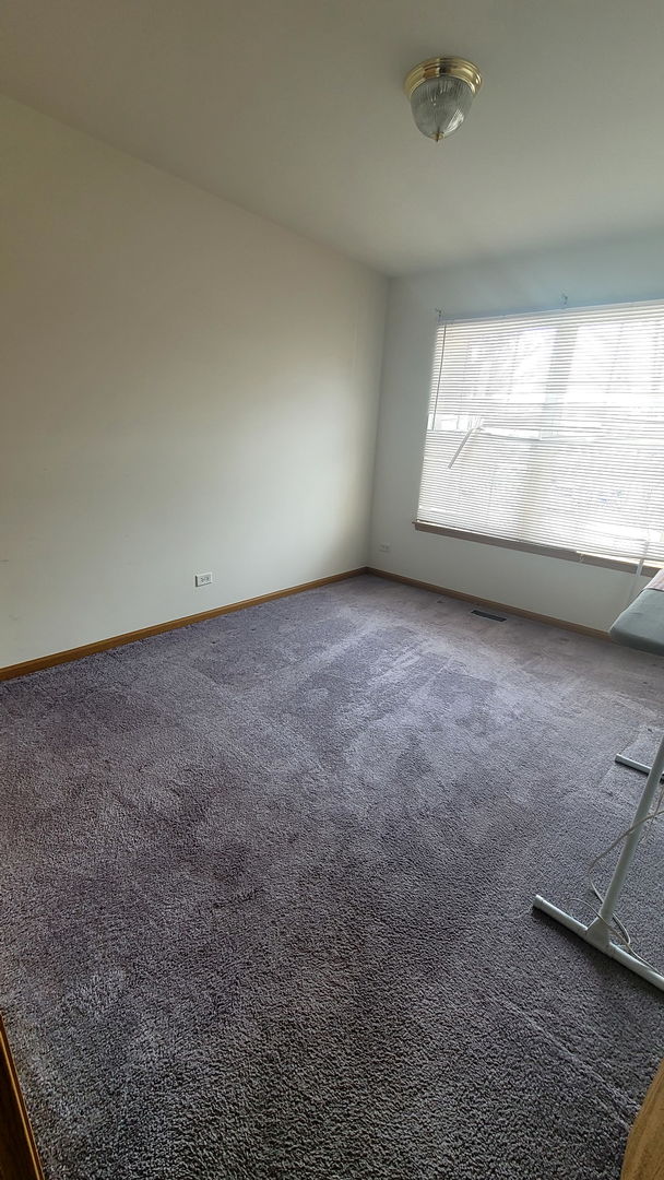 carpeted spare room with baseboards