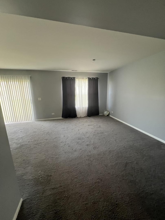 unfurnished room featuring baseboards and carpet floors