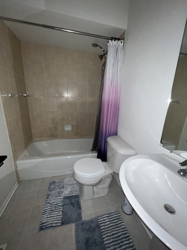 bathroom with tile patterned flooring, shower / bathtub combination with curtain, a sink, and toilet