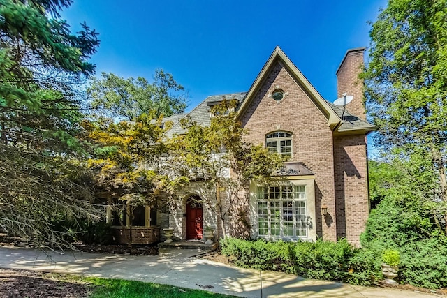 105 Fuller Rd, Hinsdale, IL 60521 - view of front of house with brick siding and a chimney