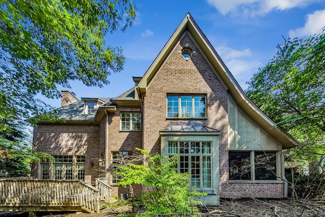 105 Fuller Rd, Hinsdale, IL 60521 - back of house featuring brick siding, a deck, and a chimney