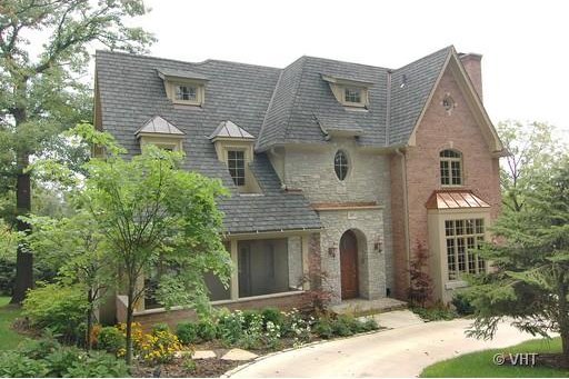 105 Fuller Rd, Hinsdale, IL 60521 - view of front of house featuring stone siding and a chimney