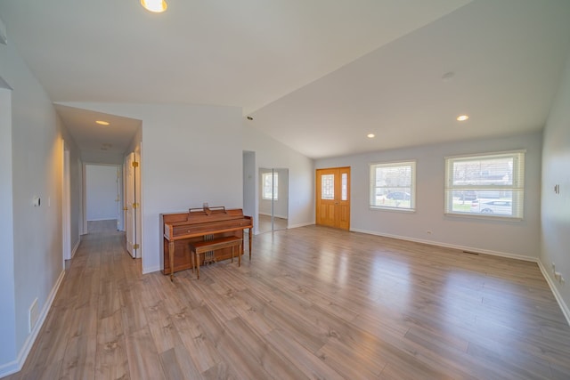 entryway with vaulted ceiling, baseboards, recessed lighting, and light wood-style flooring