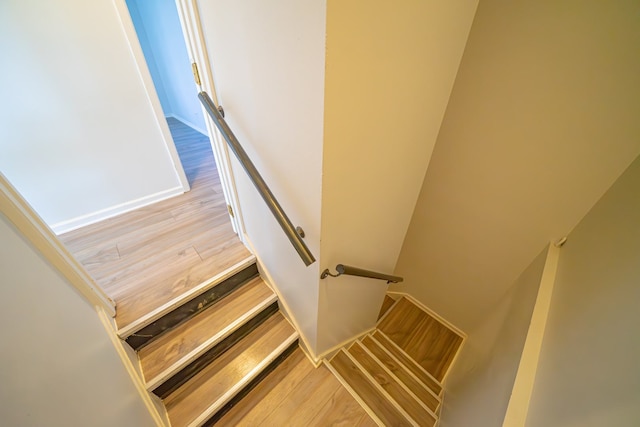 staircase featuring wood finished floors