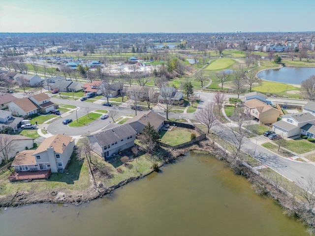 birds eye view of property with golf course view, a water view, and a residential view