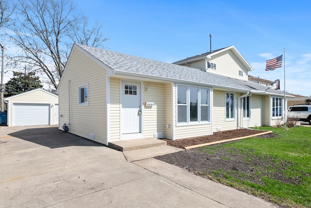 8907 S Komensky Ave, Hometown, IL 60456 - view of front of home with a front yard, a shingled roof, a detached garage, aphalt driveway, and an outdoor structure