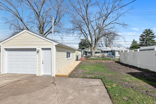 8907 S Komensky Ave, Hometown, IL 60456 - view of yard featuring an outdoor structure, a detached garage, fence, and concrete driveway