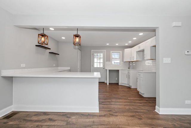 8907 S Komensky Ave, Hometown, IL 60456 - kitchen featuring dark wood-type flooring, a peninsula, white cabinetry, recessed lighting, and baseboards