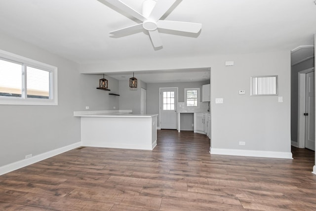 8907 S Komensky Ave, Hometown, IL 60456 - unfurnished living room with dark wood-style flooring, baseboards, and a ceiling fan