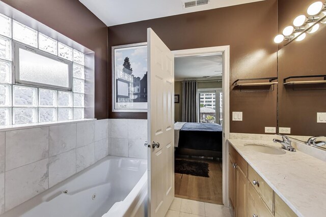 4860 N Kenmore Ave Unit 4S, Chicago, IL 60640 - bathroom with connected bathroom, a tub with jets, vanity, and tile patterned flooring