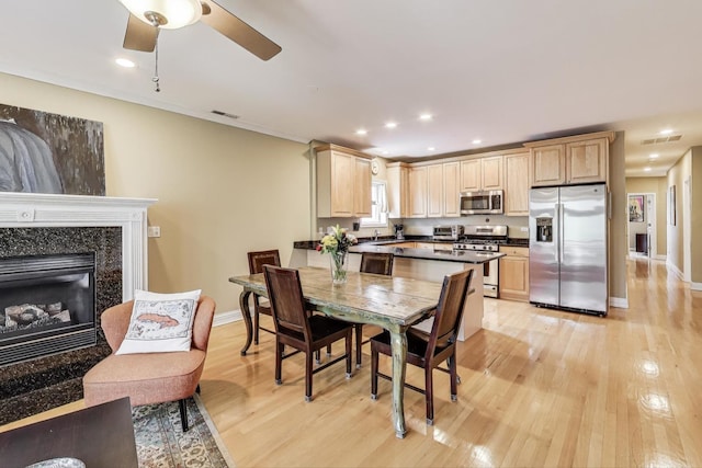 4860 N Kenmore Ave Unit 4S, Chicago, IL 60640 - dining area featuring light wood finished floors, baseboards, a ceiling fan, recessed lighting, and a high end fireplace