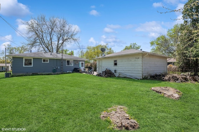 rear view of house with a yard