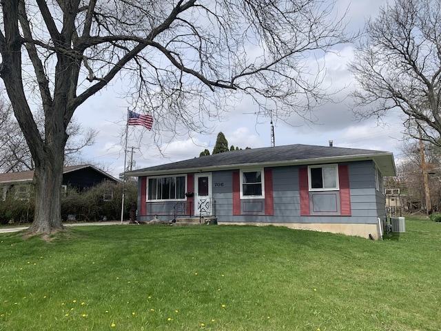 view of front of property with a front lawn and cooling unit