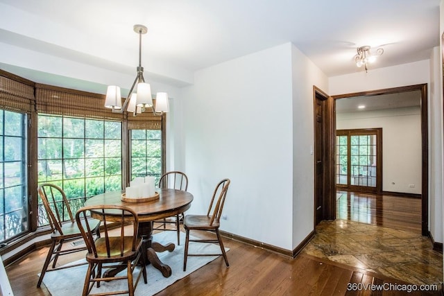304 Polo Ln, Oak Brook, IL 60523 - dining area with wood finished floors, baseboards, and a chandelier