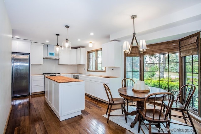 304 Polo Ln, Oak Brook, IL 60523 - kitchen featuring fridge, butcher block countertops, a center island, dark wood-type flooring, and white cabinets
