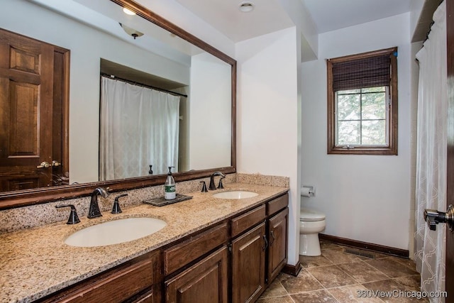 304 Polo Ln, Oak Brook, IL 60523 - full bathroom with double vanity, toilet, and baseboards