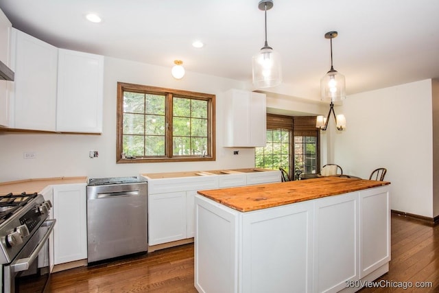 304 Polo Ln, Oak Brook, IL 60523 - kitchen with stainless steel appliances, wood counters, white cabinets, a kitchen island, and recessed lighting