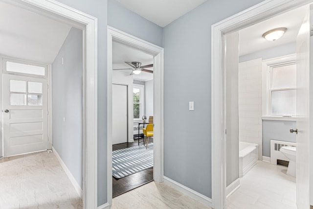 full bath featuring toilet, marble finish floor, ceiling fan, and baseboards