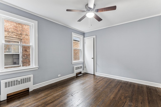 empty room with ceiling fan, baseboards, radiator, and wood finished floors