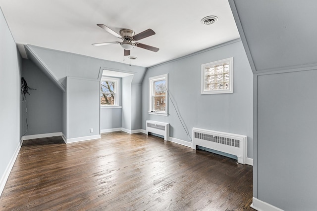 bonus room with radiator, ceiling fan, visible vents, and wood finished floors