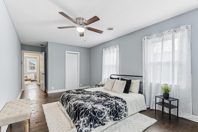bedroom featuring dark wood-style flooring, baseboards, and visible vents