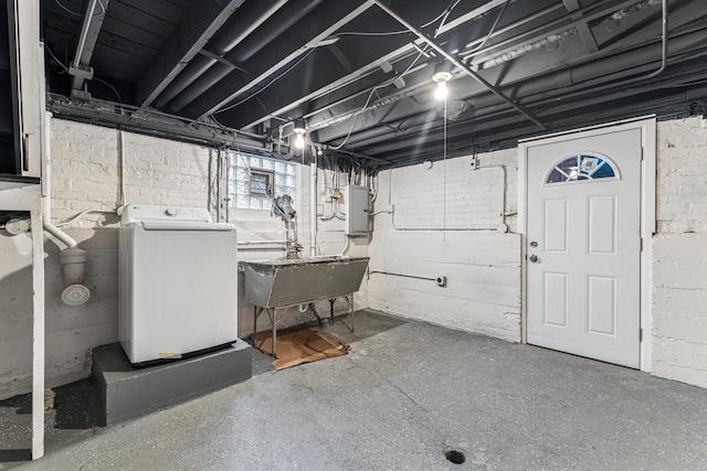 below grade area featuring washer / clothes dryer, a sink, and electric panel
