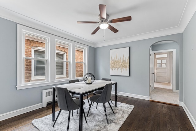 dining area featuring radiator heating unit, dark wood-type flooring, baseboards, and ceiling fan