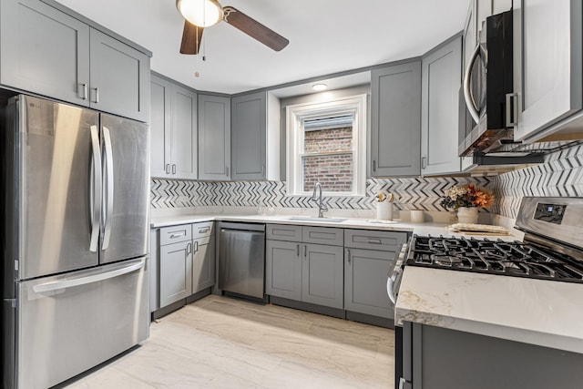 kitchen with appliances with stainless steel finishes and gray cabinetry