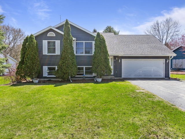 view of front facade with a garage, a shingled roof, a front lawn, and driveway