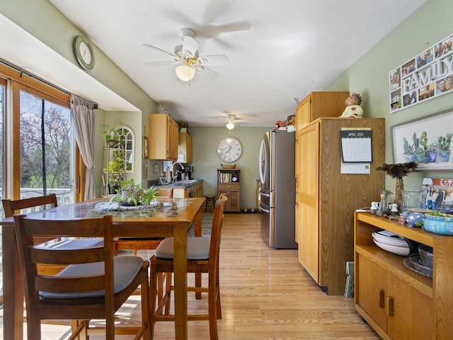 dining area featuring a ceiling fan and light wood-style flooring