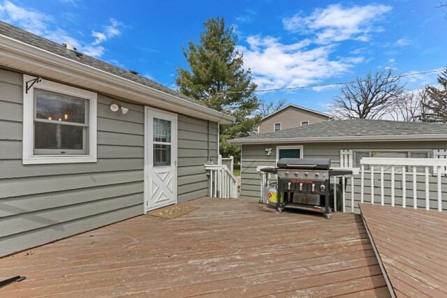 wooden terrace featuring a grill
