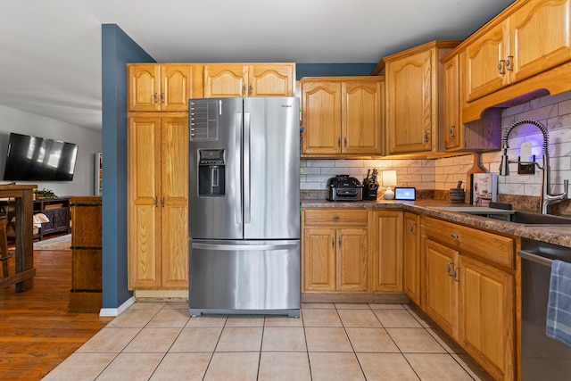 1407 Centennial Dr, Champaign, IL 61821 - kitchen with appliances with stainless steel finishes, decorative backsplash, dark countertops, and light tile patterned flooring