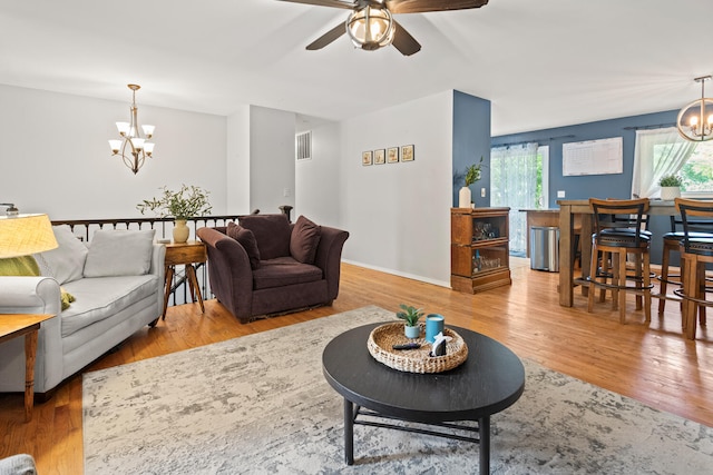 1407 Centennial Dr, Champaign, IL 61821 - living room featuring a chandelier, a ceiling fan, and wood finished floors