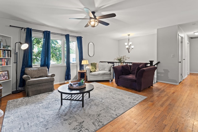 1407 Centennial Dr, Champaign, IL 61821 - living room featuring a ceiling fan, light wood-type flooring, and a chandelier