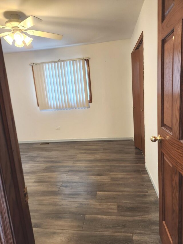 11723 S S Ave J, Chicago, IL 60617 - empty room with dark wood-style floors, baseboards, and a ceiling fan