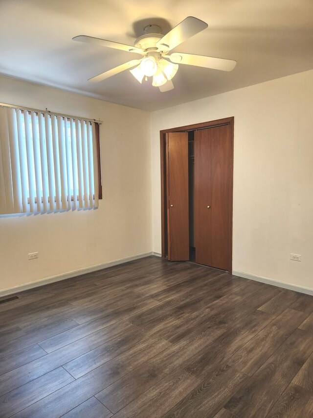 11723 S S Ave J, Chicago, IL 60617 - unfurnished bedroom with a closet, baseboards, visible vents, a ceiling fan, and dark wood finished floors