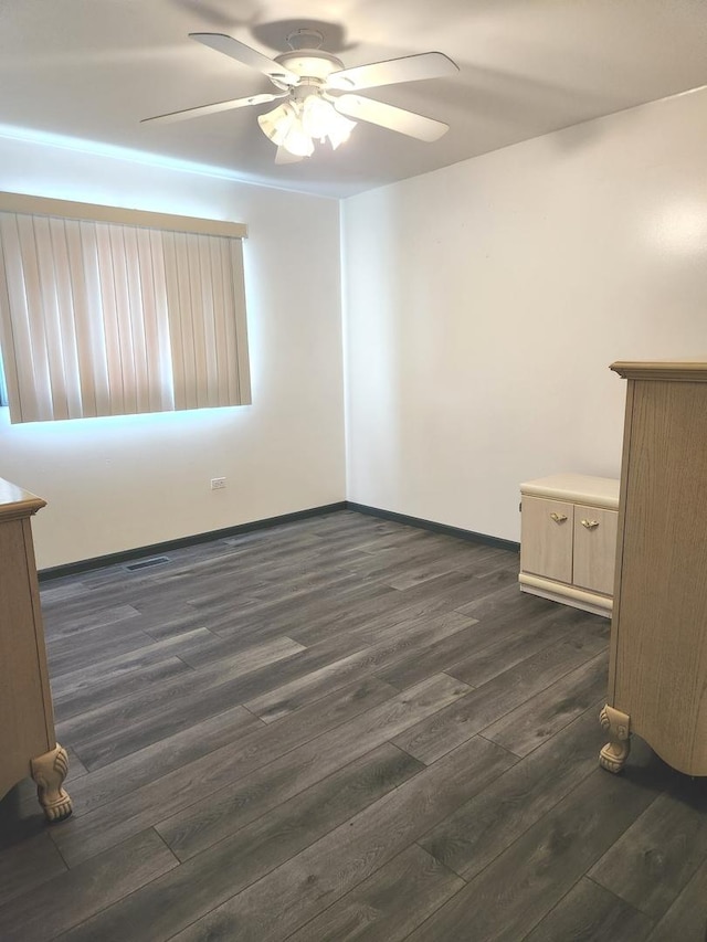 11723 S S Ave J, Chicago, IL 60617 - unfurnished room featuring dark wood-type flooring, visible vents, baseboards, and a ceiling fan