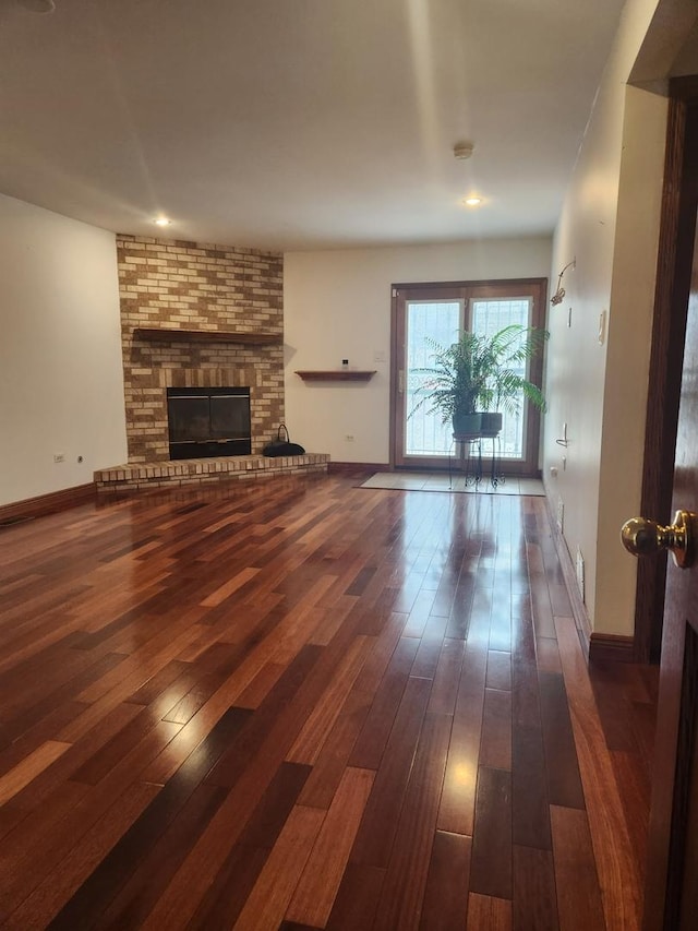 11723 S S Ave J, Chicago, IL 60617 - unfurnished living room with baseboards, hardwood / wood-style floors, and a brick fireplace