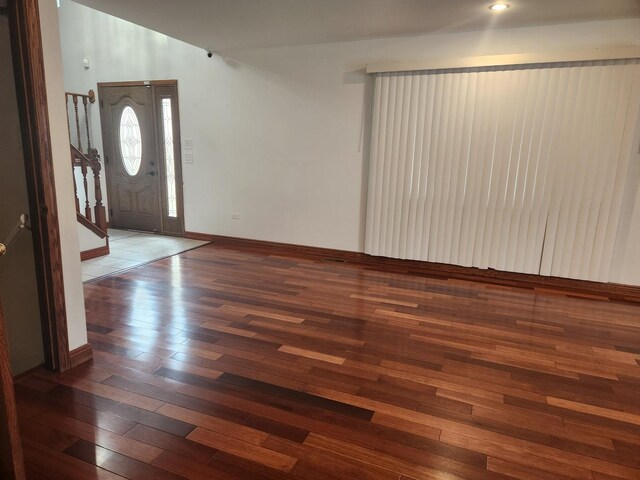 11723 S S Ave J, Chicago, IL 60617 - entryway featuring wood-type flooring, vaulted ceiling, baseboards, and stairway