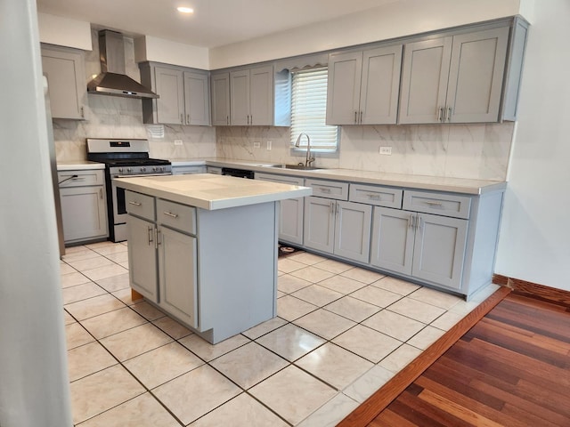 11723 S S Ave J, Chicago, IL 60617 - kitchen with a sink, wall chimney exhaust hood, stainless steel range with gas cooktop, and gray cabinets