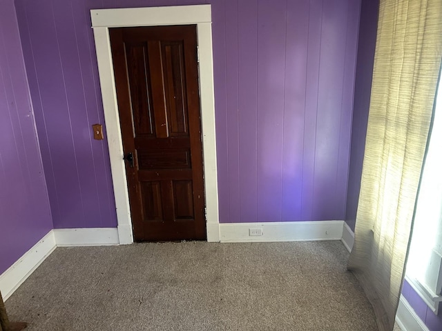 spare room with carpet floors and baseboards