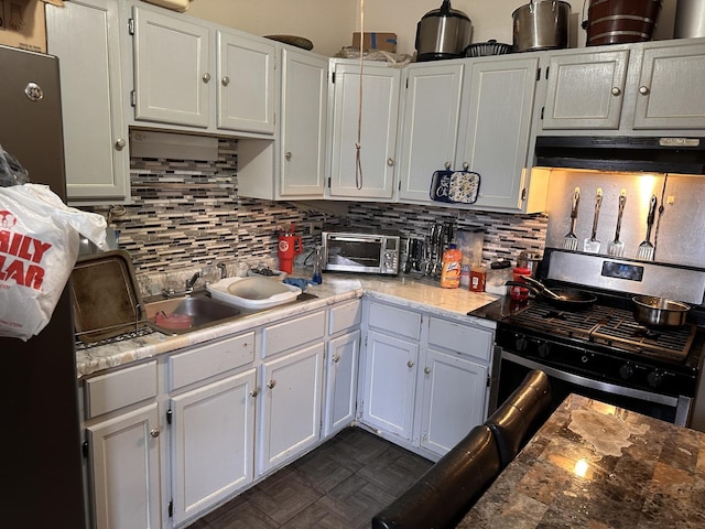1842 S Drake Ave, Chicago, IL 60623 - kitchen featuring white cabinets, under cabinet range hood, gas range, and decorative backsplash